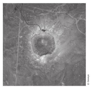 The satellite photograph below shows a large meteorite crater that is 1200 m in diameter and 170 m