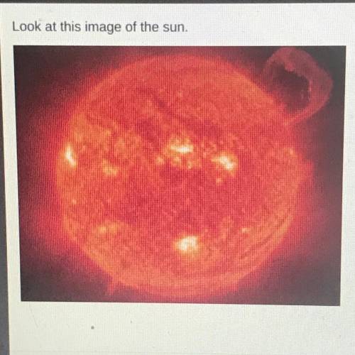 Look at this image of the sun

This image helps readers better understand the sun by
O showing tha